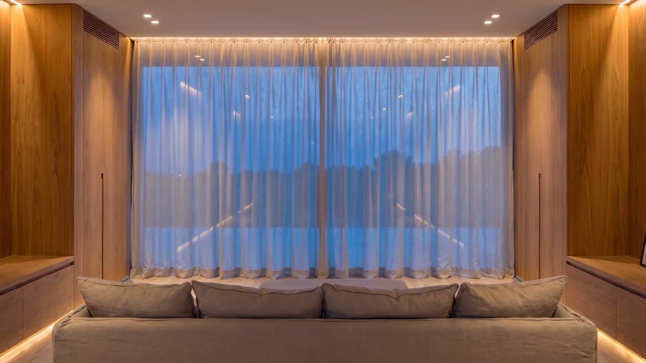 The window wall with the sheers drawn back